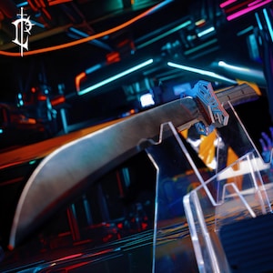 May include: A curved, silver-colored sword with a detailed blue and silver hilt is displayed on a clear acrylic stand. The blade has a worn, metallic appearance. The background features neon lights in blue, orange, and pink.