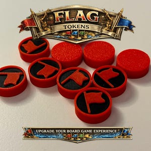 May include: A collection of red and black game tokens with flag symbols. The tokens are round with a red border and a black center. The image also includes the text "FLAG TOKENS".