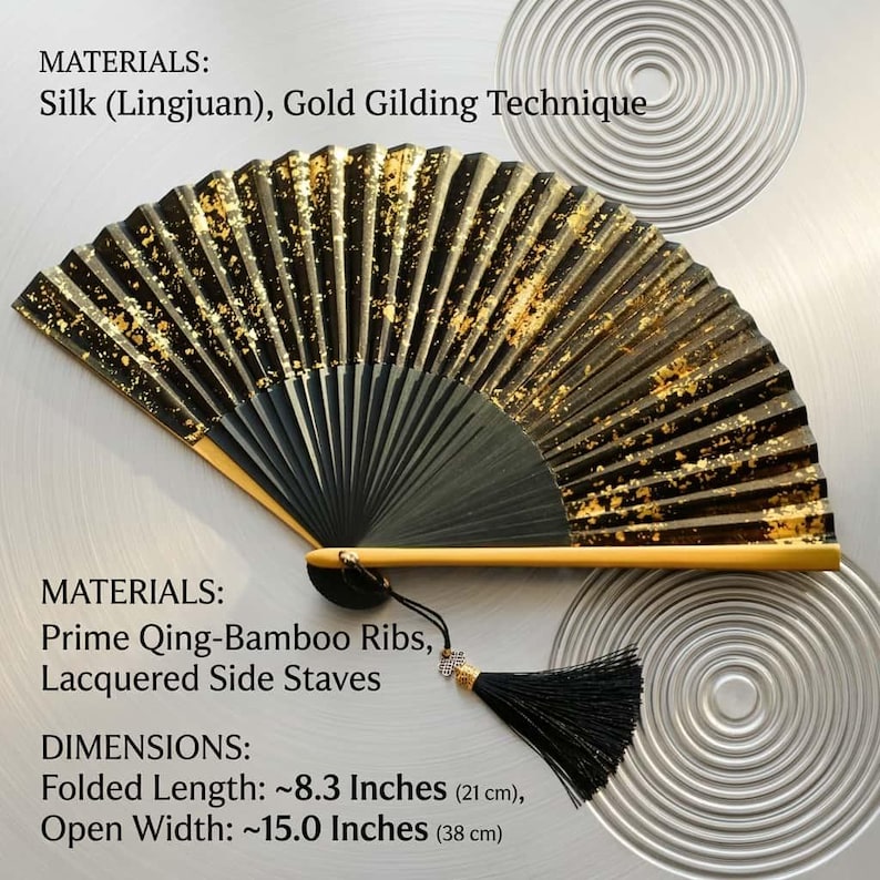 May include: A black and gold hand fan with a tassel. The fan is made of silk and bamboo, with gold gilding. Folded length is approximately 8.3 inches (21 cm), and open width is approximately 15.0 inches (38 cm).