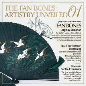 May include: A dark green hand fan with a detailed illustration of cranes in flight. The fan features the text "THE FAN BONES: ARTISTRY UNVEILED" and information about the fan's origin and craftsmanship. A green tassel hangs from the handle.