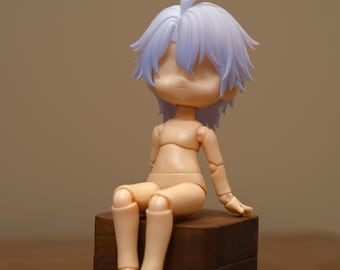 May include: A poseable doll with a blank face and light purple hair. The doll is sitting on a dark wooden block. The doll's skin is a pale peach color, and the joints are visible.