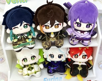 May include: Six plush dolls arranged on a white shelf. Top row: Venti in green, Zhongli in brown, and Raiden in purple. Bottom row: Nahida in white and green, Furina in blue and white, and Mavuika in red and black. Each doll features embroidered facial details.