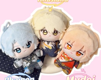 May include: Three plush dolls with anime-style features. One doll has light blue hair and is labeled "Phainon." Another has blonde hair and is labeled "Khaslana." The third doll has peach-colored hair and is labeled "Mydei."