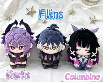 May include: Three plush dolls labelled Flins, Durin, and Columbina. The left doll has purple hair and horns. The centre doll has dark blue hair. The right doll has black hair with pink streaks and small wings. Each doll features detailed outfits.