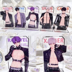 May include: A collection of seven acrylic character standees featuring anime-style figures with exposed torsos, wearing black leather-style harnesses, jackets, and accessories. Each standee displays a name and the text Love and Deep Space.