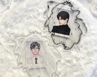 May include: Two decorative acrylic photo frames featuring a layered veil design. One frame is clear with a white veil and a portrait of a person in a white shirt. The other is clear with a black lace veil and a portrait of a person in a black shirt.