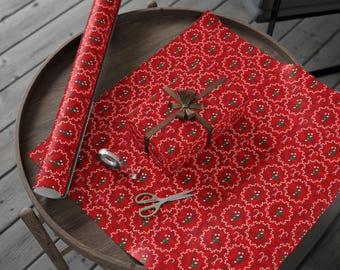 May include: Red wrapping paper with a repeating pattern of white candy canes and green accents. A wrapped gift with a brown ribbon, scissors, and tape are on the paper. A roll of the same wrapping paper is on the table.