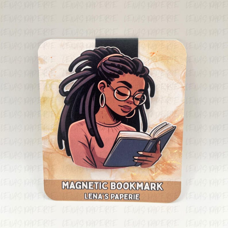 May include: Magnetic bookmark featuring an illustration of a Black woman with locs wearing glasses, reading a book. The bookmark has a brown border and the text "MAGNETIC BOOKMARK LENA'S PAPERIE". The background has a watercolor effect.