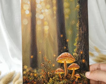May include: A rectangular painting on a flat surface depicting a forest scene with four glowing mushrooms in the foreground. The background features tall dark tree trunks and soft golden light bokeh effects, creating a warm, illuminated atmosphere.