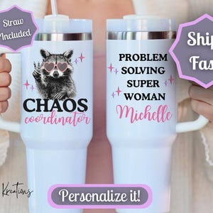 May include: White insulated tumbler with a handle, featuring a raccoon wearing heart-shaped sunglasses and the text "CHAOS coordinator." The other tumbler has the text "PROBLEM SOLVING SUPER WOMAN Michelle." Includes a straw.