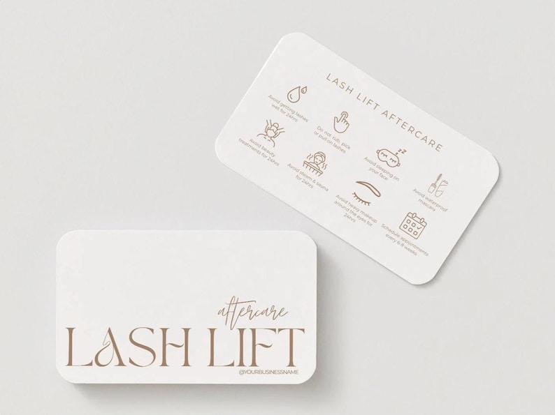 May include: Two white, rounded-corner cards with brown text and illustrations. One card reads "LASH LIFT" with "aftercare" above it. The other card has "LASH LIFT AFTERCARE" at the top, with icons and text detailing aftercare instructions.