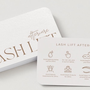 May include: White, rounded-corner cards with the words "LASH LIFT" and "aftercare" in a brown, elegant font. The smaller card has aftercare instructions with icons and text, including "Avoid getting lashes wet for 24hrs."