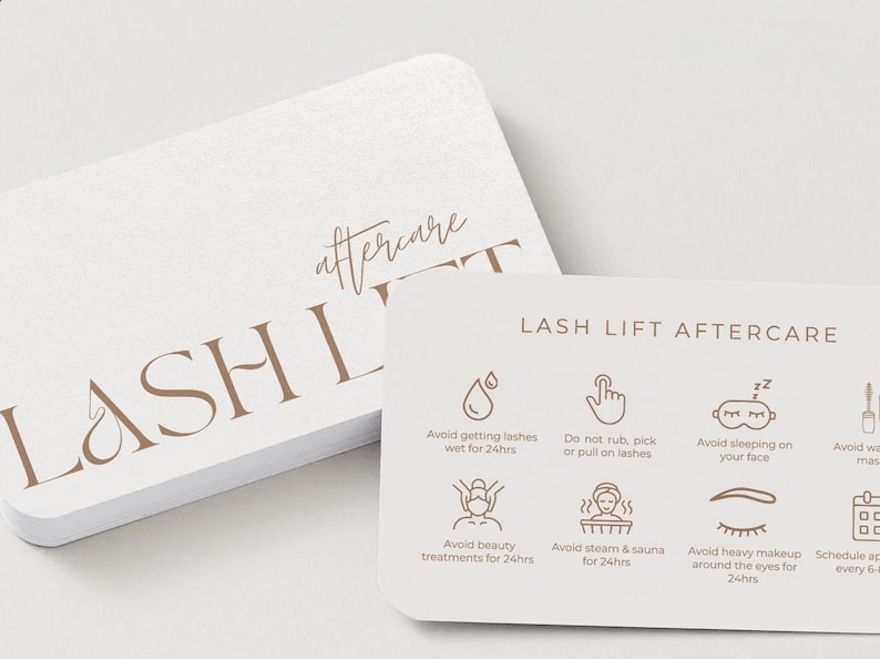 May include: White, rounded-corner cards with the words "LASH LIFT" and "aftercare" in a brown, elegant font. The smaller card has aftercare instructions with icons and text, including "Avoid getting lashes wet for 24hrs."