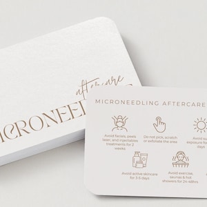 May include: A stack of white, rounded-corner cards with the words "MICRONEEDLING AFTERCARE INSTRUCTIONS" and "MICRONEED" printed in a light brown color. The cards provide aftercare advice with icons and text.