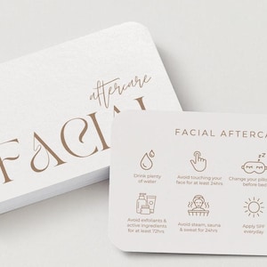 Op de afbeelding: Een stapel witte kaarten met afgeronde hoeken met de woorden "FACIAL AFTERCARE" in bruin script. De kaarten geven nazorginstructies met pictogrammen en tekst, zoals water drinken en zonnebrandcrème aanbrengen.