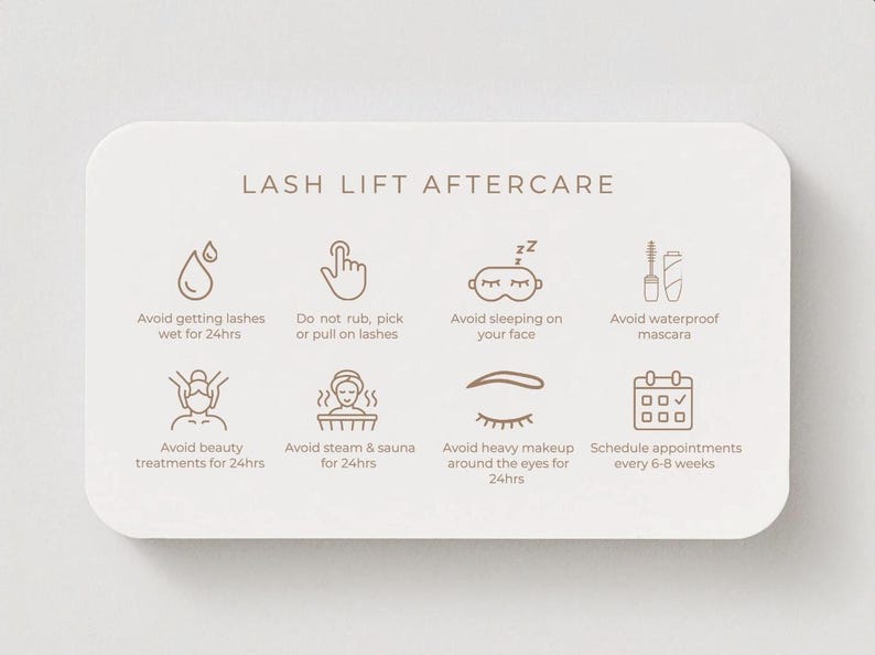 May include: A cream-colored card with rounded corners displays "LASH LIFT AFTERCARE" text and icons with instructions. The icons advise avoiding getting lashes wet, rubbing, sleeping on the face, and waterproof mascara. It also suggests avoiding beauty treatments, steam, heavy makeup, and scheduling appointments.