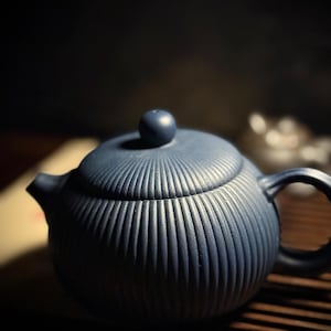 May include: A blue ceramic teapot with a ribbed design. The teapot has a lid with a small knob and a curved handle. The spout is small and angled. The teapot is sitting on a wooden surface.