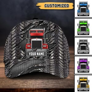 May include: A black baseball cap with a tire tread pattern and a red semi-truck graphic. The cap has the word "CUSTOMIZED" in gold and the text "YOUR NAME" on the truck. Additional images show the truck in various colors.