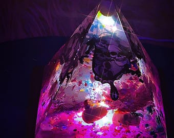 Epoxy resin healing pyramid with natural crystal and dried pressed leaves and flowers