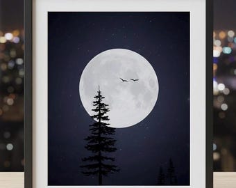 May include: Framed art print featuring a full moon in a dark blue night sky with stars. Silhouetted pine trees are in the foreground, and two birds fly across the moon. The artwork is in a black frame with a white mat.