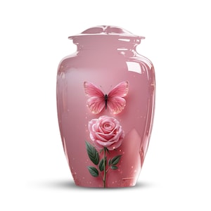 May include: A pink urn with a butterfly and rose design. The urn has a glossy finish and a decorative butterfly and rose are featured on the front. The butterfly is pink with gold accents, and the rose is a soft pink colour.