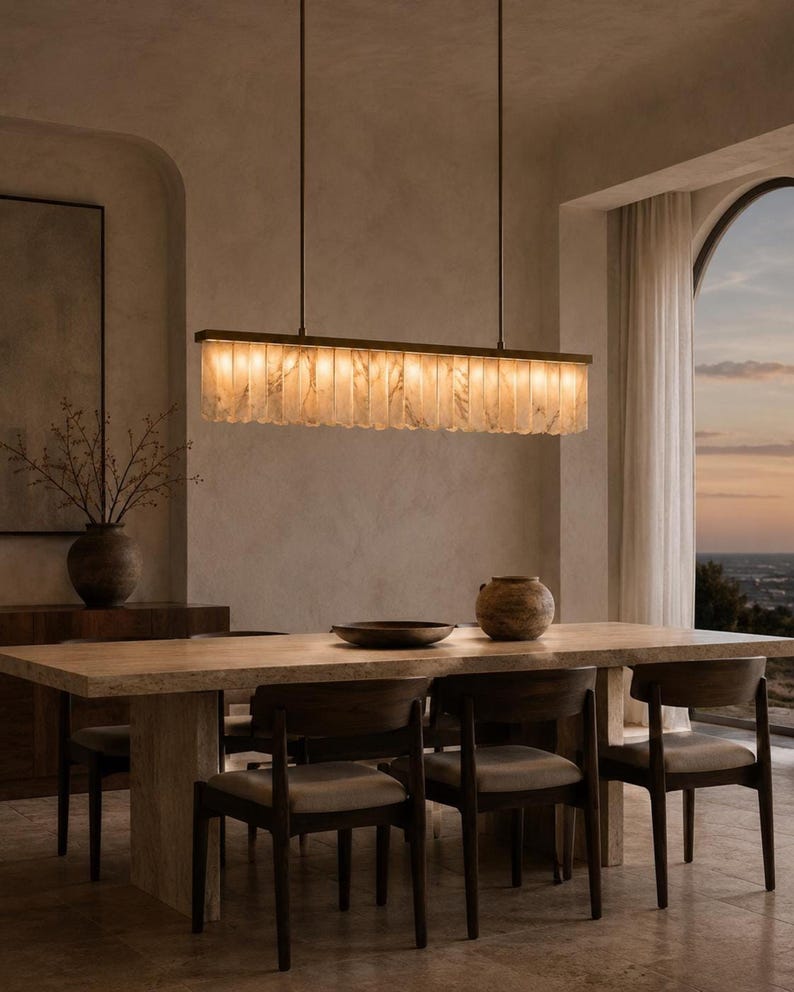 Wabi sabi alabaster dining room chandelier, long narrow stone fins, airy windowed banquet setting