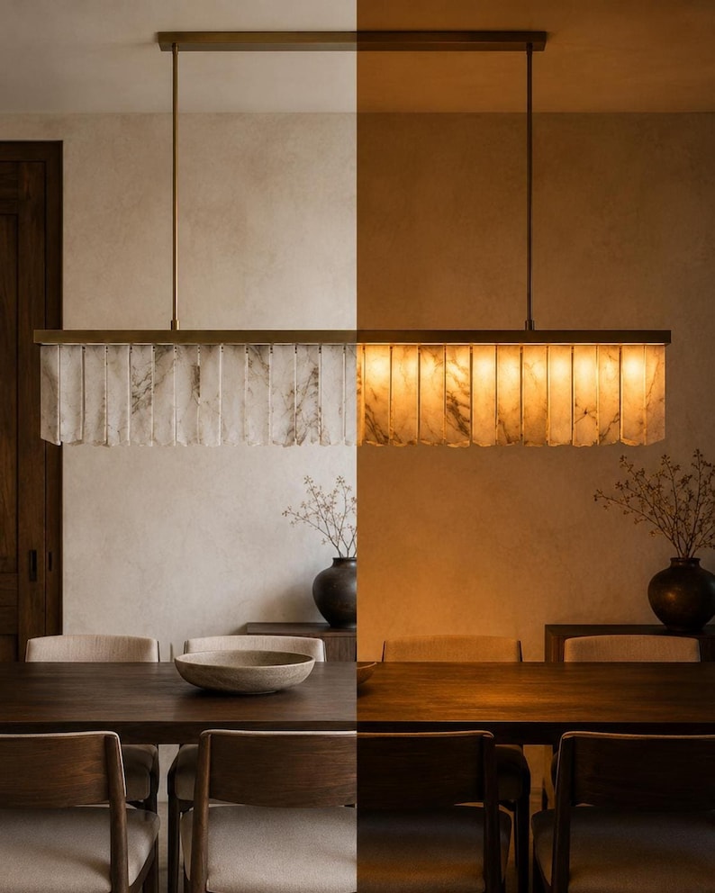 Modern alabaster chandelier above dining table, slim brass canopy, soft amber light and veining