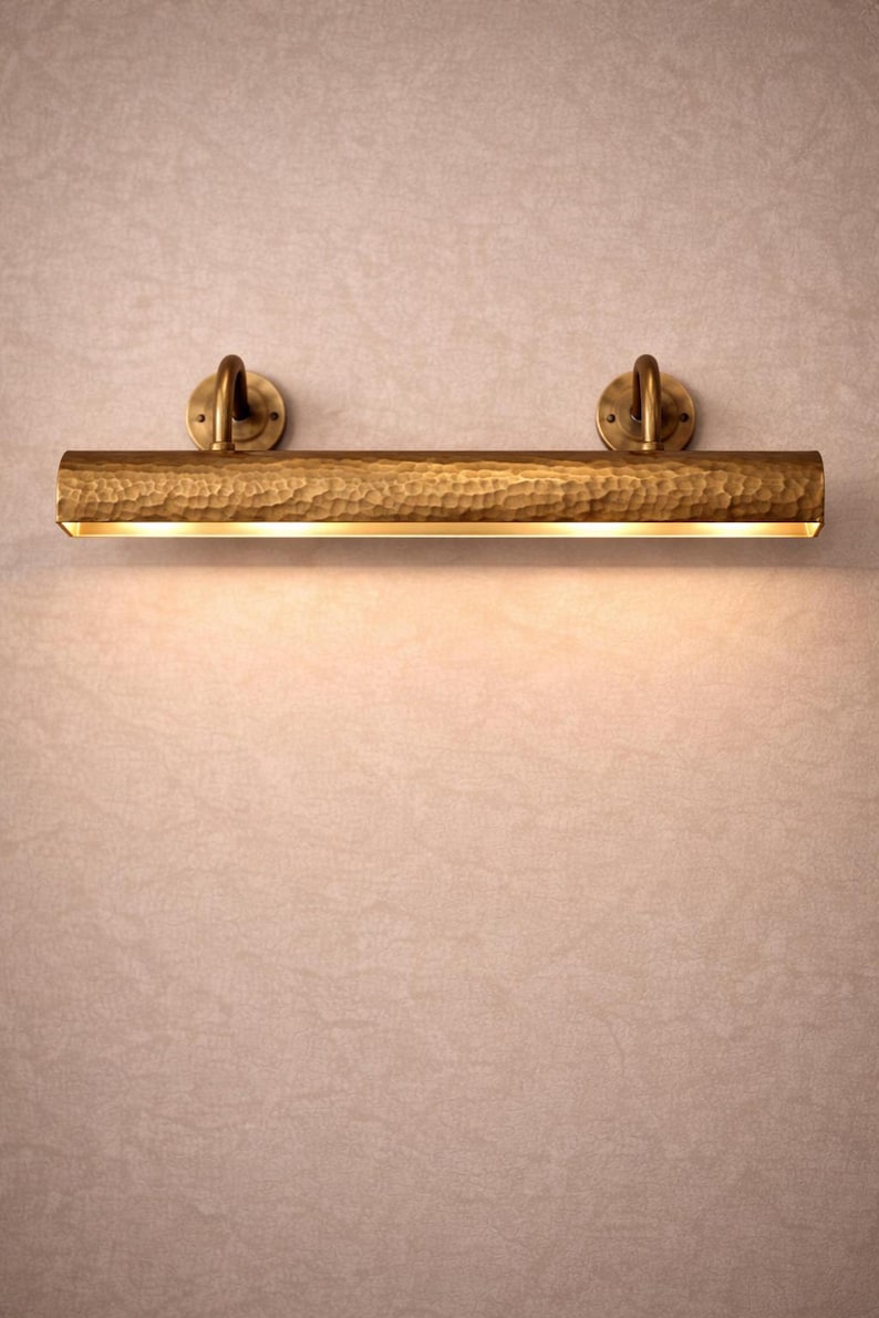 solid brass picture light, front view close to wall, antique brass finish, focused museum art light