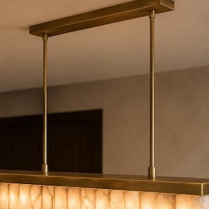 Brass canopy and rigid rods detail, modern alabaster chandelier hardware, textured stone edge