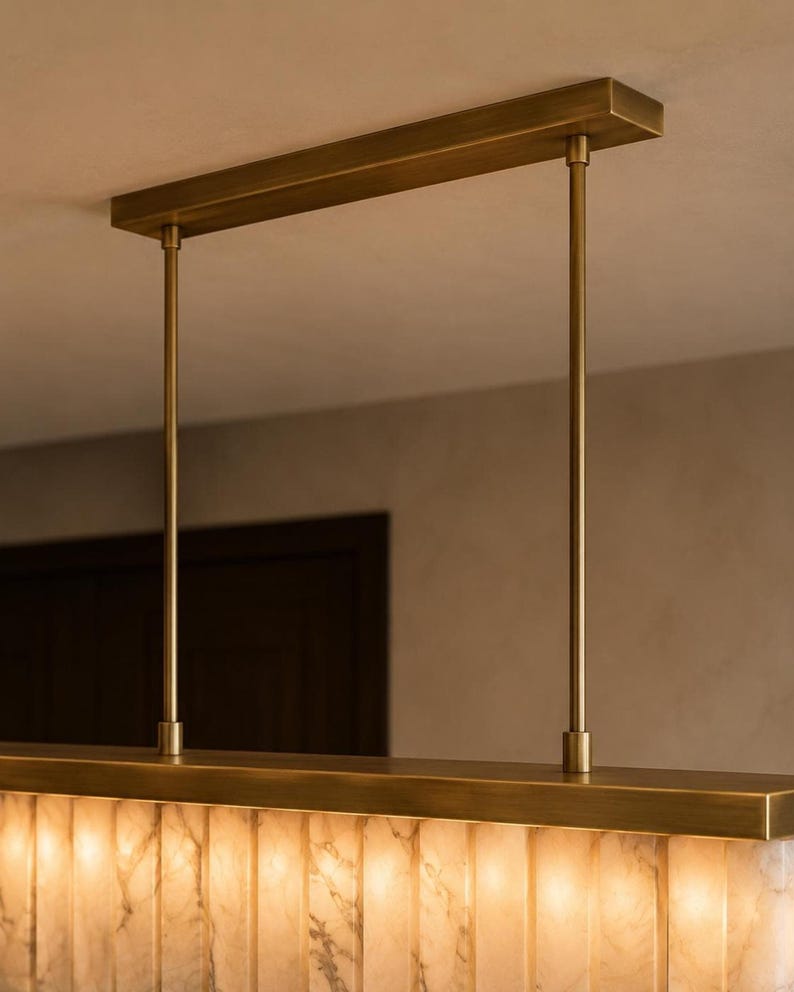 Brass canopy and rigid rods detail, modern alabaster chandelier hardware, textured stone edge