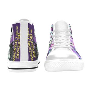 May include: A white ceramic mug with a black handle and the text "But First, Coffee" in a bold, black font. The mug is on a wooden surface. The mug appears to be approximately 355 ml.