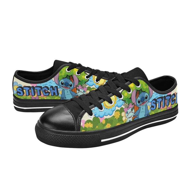 May include: Pair of black and white canvas trainers featuring a colourful design with the word "STITCH" in blue and images of the character Stitch. The shoes have black laces and a black toe cap.