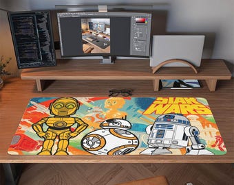 May include: A Star Wars-themed desk mat featuring C-3PO, BB-8, and R2-D2 characters. The mat has a colorful design with the Star Wars logo in yellow. The mat is rectangular and sits on a wooden desk.