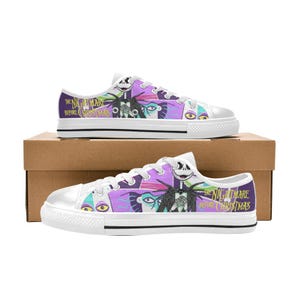 May include: White canvas sneakers featuring a colorful design from "The Nightmare Before Christmas." The shoes display Jack Skellington and other characters in shades of purple, black, and teal. The text "The Nightmare Before Christmas" is printed on the side.