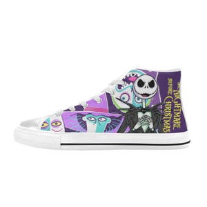 May include: High-top canvas trainers featuring characters from "The Nightmare Before Christmas." The design includes Jack Skellington, Sally, and other characters in a colorful, cartoon style. The shoes have white laces and a white rubber sole.