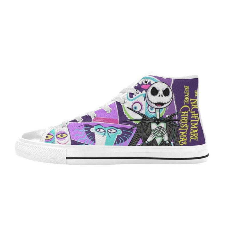 May include: High-top canvas trainers featuring characters from "The Nightmare Before Christmas." The design includes Jack Skellington, Sally, and other characters in a colorful, cartoon style. The shoes have white laces and a white rubber sole.
