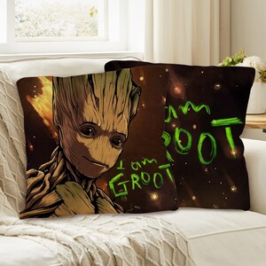 May include: Two decorative throw pillows featuring the character Groot from Guardians of the Galaxy. One pillow displays Groot's face with the text "I am Groot" in green. The other pillow has the text "I am Groot" in green on a dark background.