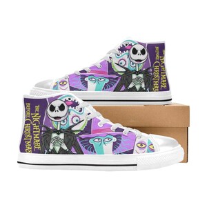 May include: High-top canvas trainers with a colourful design featuring characters from "The Nightmare Before Christmas." The shoes have a white rubber sole and laces, with the film's title printed on the side.
