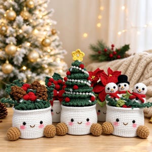 May include: Three white crocheted pots with smiling faces and brown feet. The left pot holds pinecones and holly, the center pot features a green Christmas tree with a yellow star, and the right pot contains three small snowmen.