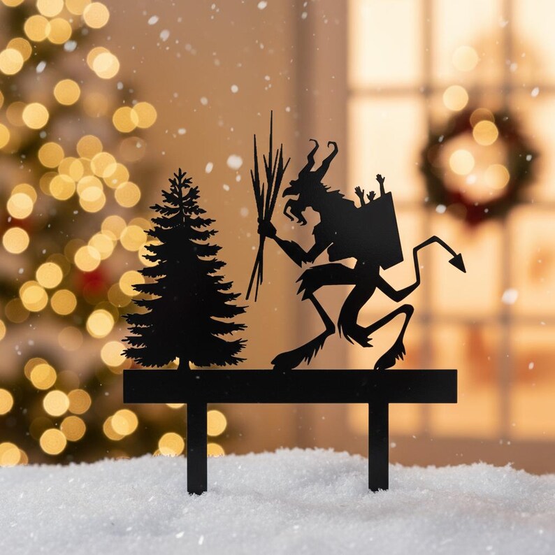 May include: Black metal Christmas decoration featuring a silhouette of a Krampus figure with a bundle of birch branches, a fir tree, and a bench. The background has a bokeh effect with Christmas lights and a wreath.