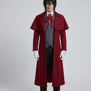 May include: A long burgundy coat with a cape detail at the shoulders. The coat is worn over a grey waistcoat, white shirt, and black trousers. A red bow tie and white gloves complete the ensemble. The coat appears to be made of a wool-like material.