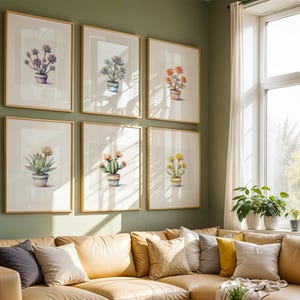 May include: Six framed botanical art prints featuring watercolor illustrations of various succulents and cacti in pots. The prints are displayed on a green wall above a tan sectional sofa with decorative pillows. The frames have a gold finish.