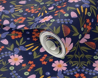May include: A roll of wallpaper featuring a floral pattern. The design includes pink flowers, orange clusters, blue butterflies, and green leaves on a dark blue background. The wallpaper is rolled up, revealing the pattern.