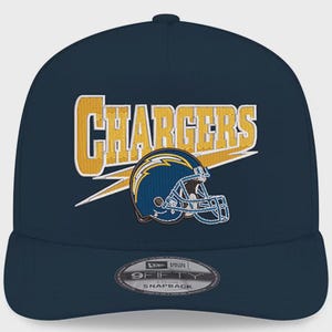 May include: A navy blue snapback cap with the word "CHARGERS" in gold with a white outline, and a blue and yellow football helmet graphic. The cap has a curved peak and a snap closure.