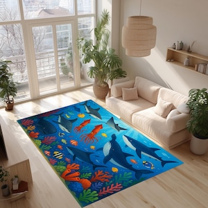 May include: A rectangular area rug featuring an underwater scene with whales, sharks, and colorful fish. The rug has a blue background with coral and other sea creatures. The rug is placed on a hardwood floor.