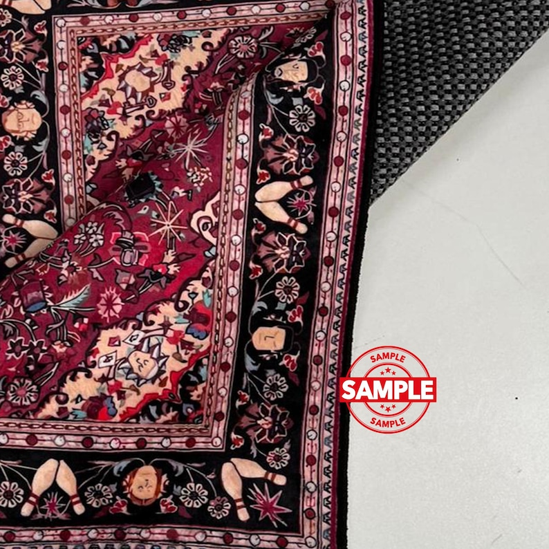 May include: A section of a detailed, ornate rug with a rich color palette. The rug features a deep red central field with floral and geometric patterns, framed by a black border with bowling pin motifs. The word "SAMPLE" is stamped on the rug.