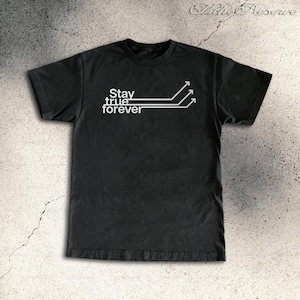 May include: Black t-shirt with the white text "Stay true forever" and three horizontal lines with arrows pointing up. The shirt is made of a soft material and has a crew neck.