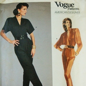 May include: Vogue Patterns American Designer sewing pattern for a jumpsuit by Anne Klein. The pattern includes two styles: a black jumpsuit with a V-neck and short sleeves and a brown jumpsuit with a wrap-style neckline and long sleeves. The pattern number is 1871.