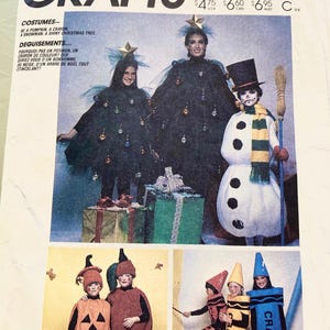 May include: A McCall's Crafts sewing pattern envelope 2617 for costumes including a pumpkin, crayon, snowman, and Christmas tree. The cover features photographs of individuals wearing these costumes, with text indicating size 6-8 and prices.