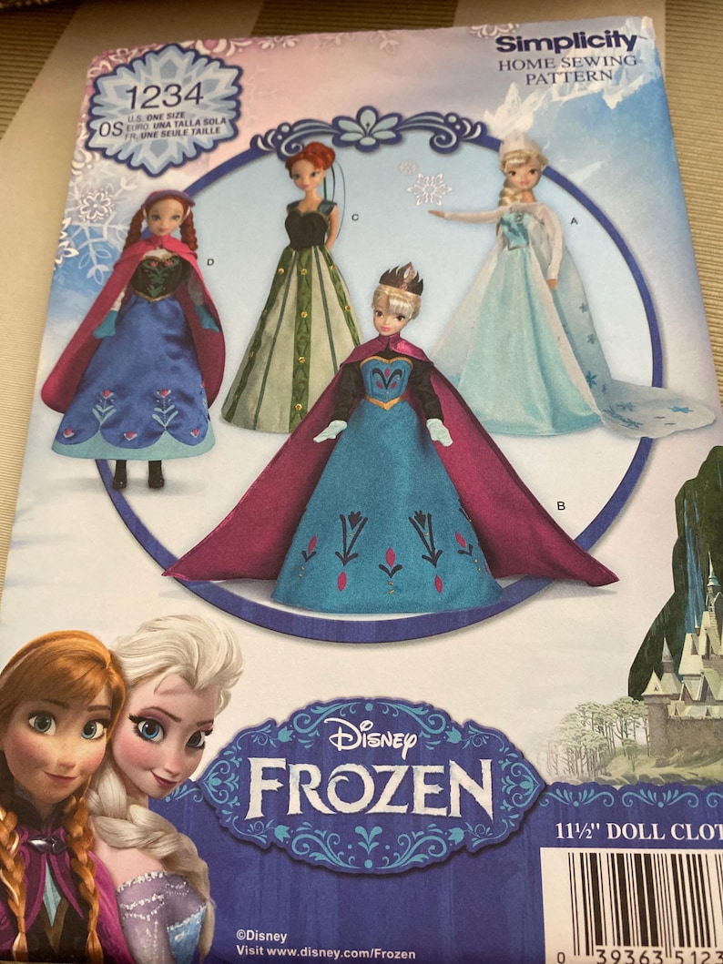 May include: A Simplicity home sewing pattern featuring Disney's Frozen characters. The pattern includes images of dolls in various outfits, with the Disney Frozen logo prominently displayed. The pattern is for 11 1/2" doll clothes.